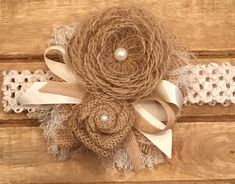 a close up of a headband made out of burlap and lace on a wooden surface