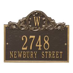 a sign that says newbury street with the letter w in gold and black on it