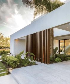 a modern house with an open front porch and stairs leading up to the entryway