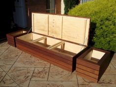 an open wooden box sitting on top of a patio