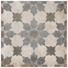 an old tile floor with star designs on the top and bottom, in shades of gray