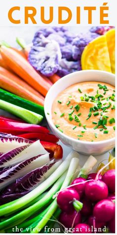 a bowl of dip surrounded by vegetables and other foods on a white plate with text overlay that reads crudite the view from great island