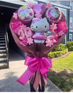 a hello kitty bouquet with balloons and other items