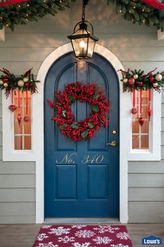 a blue front door with a wreath on it