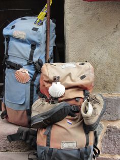 a pile of luggage sitting on top of a stone floor next to a wall and door