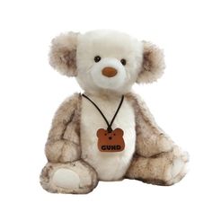 a white teddy bear with a brown tag on it's chest sitting in front of a white background