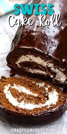 chocolate swiss cake roll is cut in half and has white frosting on the inside