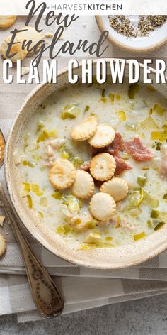 a bowl of clam chowder with crackers on the side