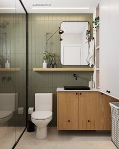 a bathroom with a sink, toilet and shower stall in the background is a green tiled wall