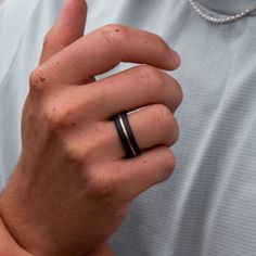 a man wearing a black wedding band and ring