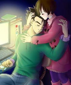 two people hugging each other in front of a computer