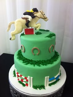 a green cake with a horse and rider on top