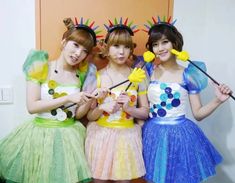 three young women dressed in costumes posing for the camera