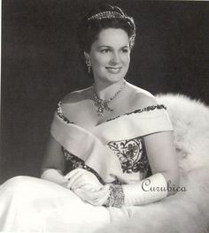 an old black and white photo of a woman wearing a tiara