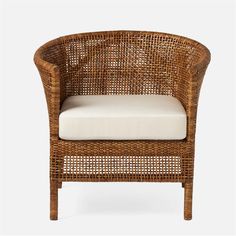 a brown wicker chair with white cushions