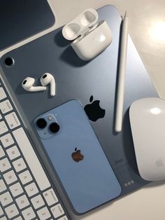 an iphone, headphones and keyboard on a table