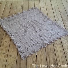 a white crocheted doily on a wooden floor with the words, the lavender chain