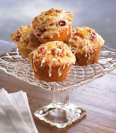 several muffins on a glass cake stand