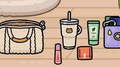 the contents of a purse are laid out on the floor next to an empty cup