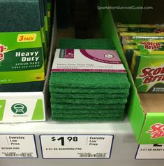 several stacks of scrubbing cloths are on display for sale in a grocery store