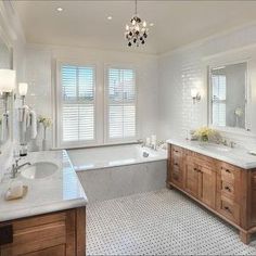 a large bathroom with two sinks and a bathtub