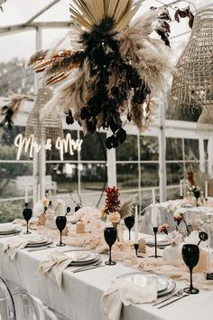 the table is set with wine glasses and place settings