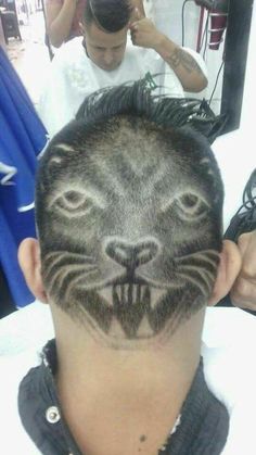 a man with a lion face on his head is shown in the middle of a haircut