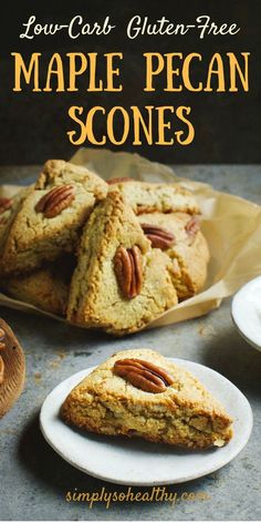 four pieces of maple pecan scones sitting on top of a white plate next to a pile of pecans