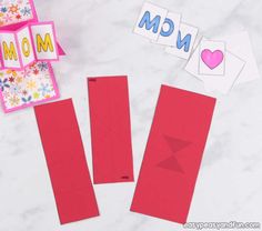 paper cut out to make mother's day cards with the word mom on them