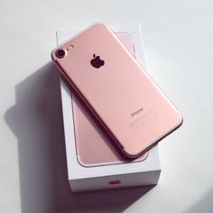 an iphone is sitting in a box on top of a white table with its lid open