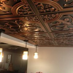 an ornately designed ceiling in a living room with mirrors and lights on the wall