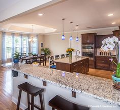 a kitchen and dining room with an island in the middle