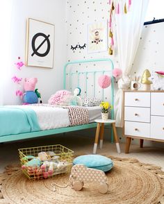 a child's bedroom decorated in pastel colors