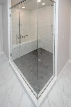 an empty bathroom with a glass shower door