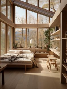 a bedroom with wooden floors and large windows on the wall, along with a bed