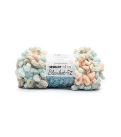 bernat fizz blanketing yarn with multicolored pom - poms