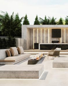 an outdoor living area with couches, tables and fireplaces in the middle of it