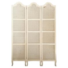 an antique white four panel screen with wicker panels