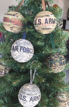 an air force christmas tree with ornaments hanging from it's branches and the words us army painted on them