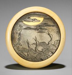 an image of two birds flying in the sky on a round object with wood frame