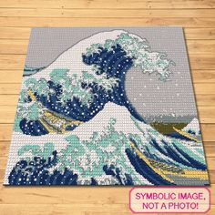 the great wave is made out of legos and has been placed on a wooden floor