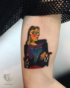 a woman's leg with a tattoo on it that has an image of a woman sitting in a chair