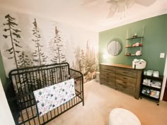 a baby's room with a crib, dresser and changing table in it