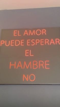 a sign that is on the side of a building with words in spanish and english