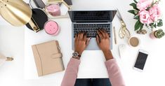 a woman is typing on her laptop surrounded by other office supplies and flowers, such as pink peonies