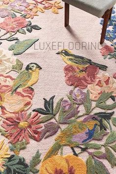 a floral rug with birds and flowers on it