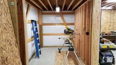 the inside of a building being built with wood framing and tools on it's sides