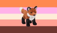 a small stuffed fox standing in front of a pink and orange striped background with white stripes