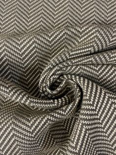 a close up view of a grey and white herringy fabric with an interesting pattern