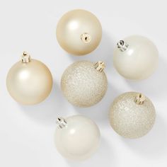 white and gold christmas ornaments on a white background